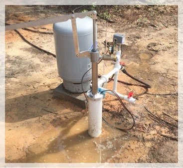 Wellhead and pressure tank at a rural Mississippi property
